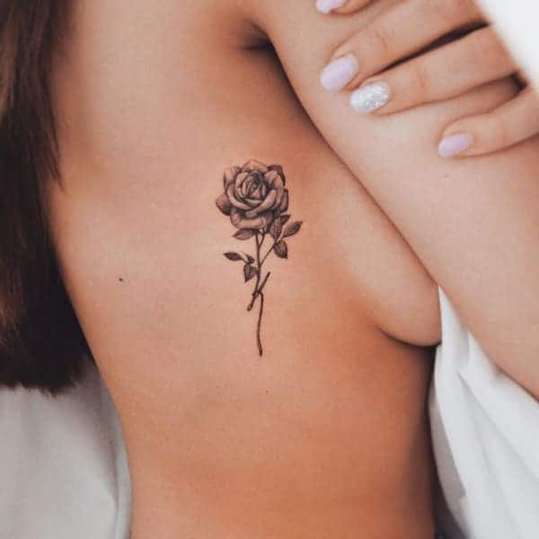 Single needle rose tattoo on the left breast